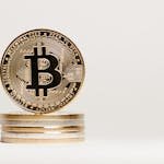 Golden Bitcoin displayed prominently on a white background showcasing cryptocurrency value.